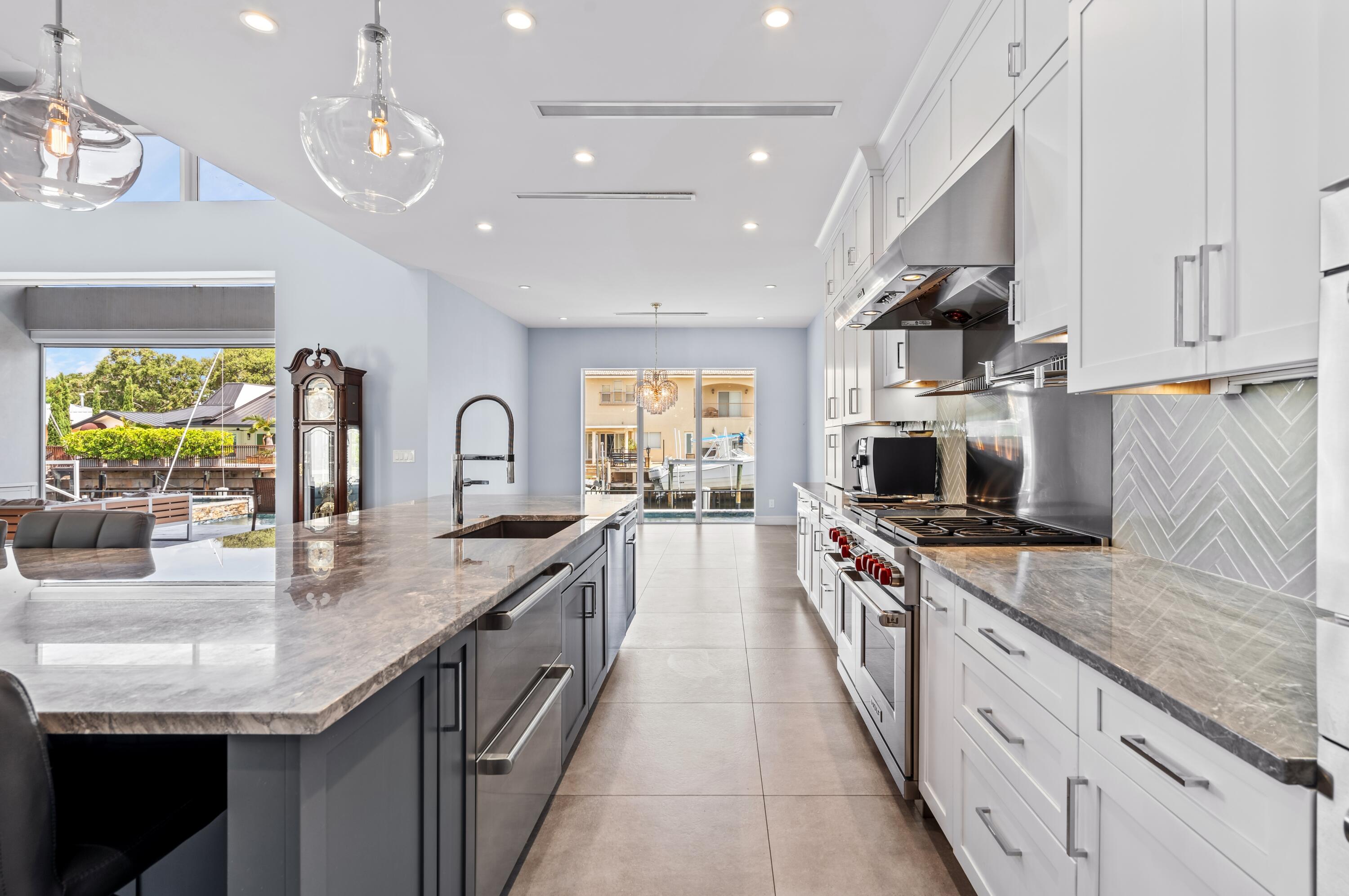 807 Dover Street Boca Raton, FL 33487 - Photo 8 of 47 a large kitchen with stainless steel appliances granite countertop a lot of counter space and wooden floor