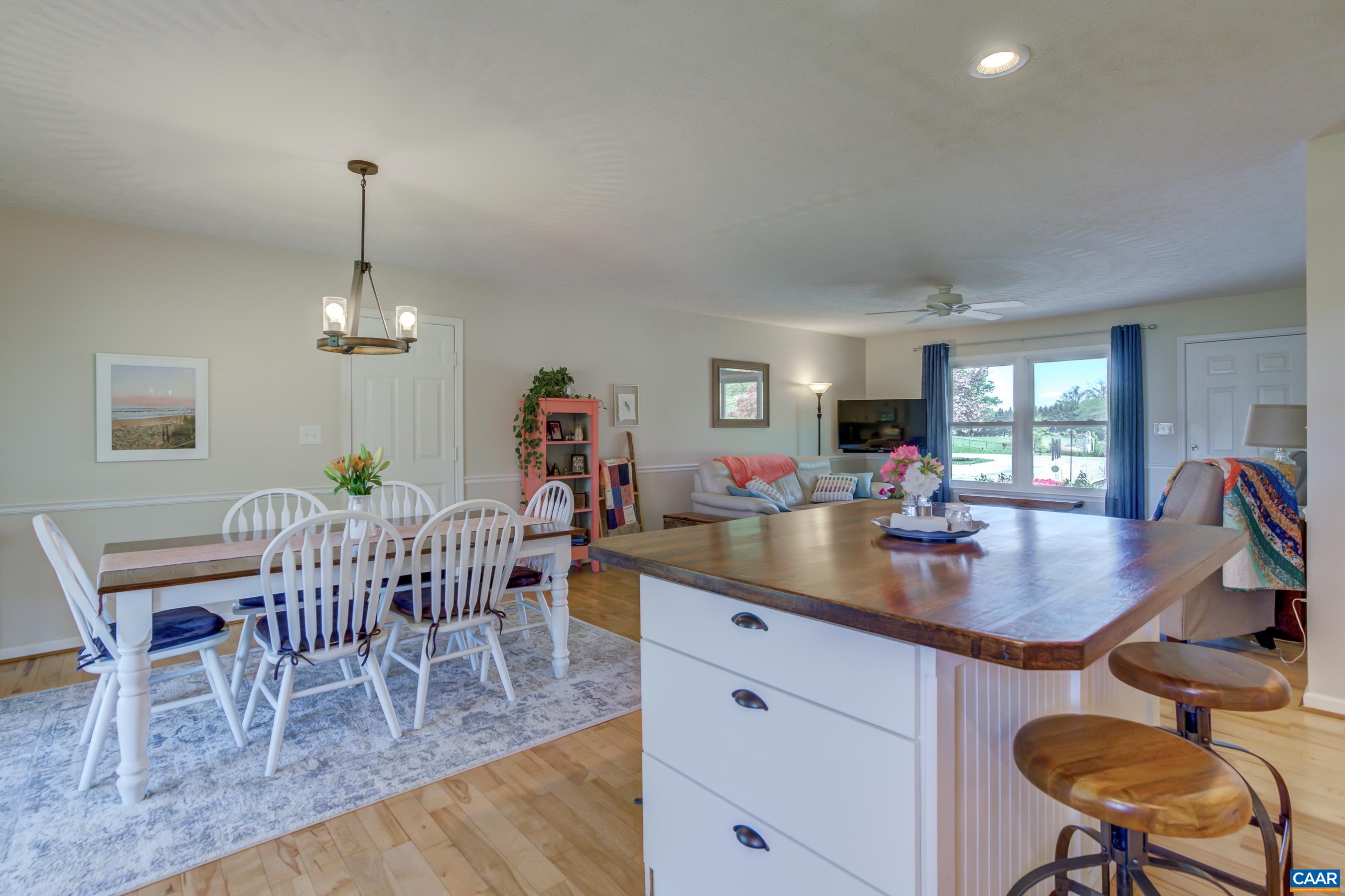120 Meadowview Lane Ruckersville, VA 22968 - Photo 18 of 53 a dining room with furniture a chandelier and wooden floor