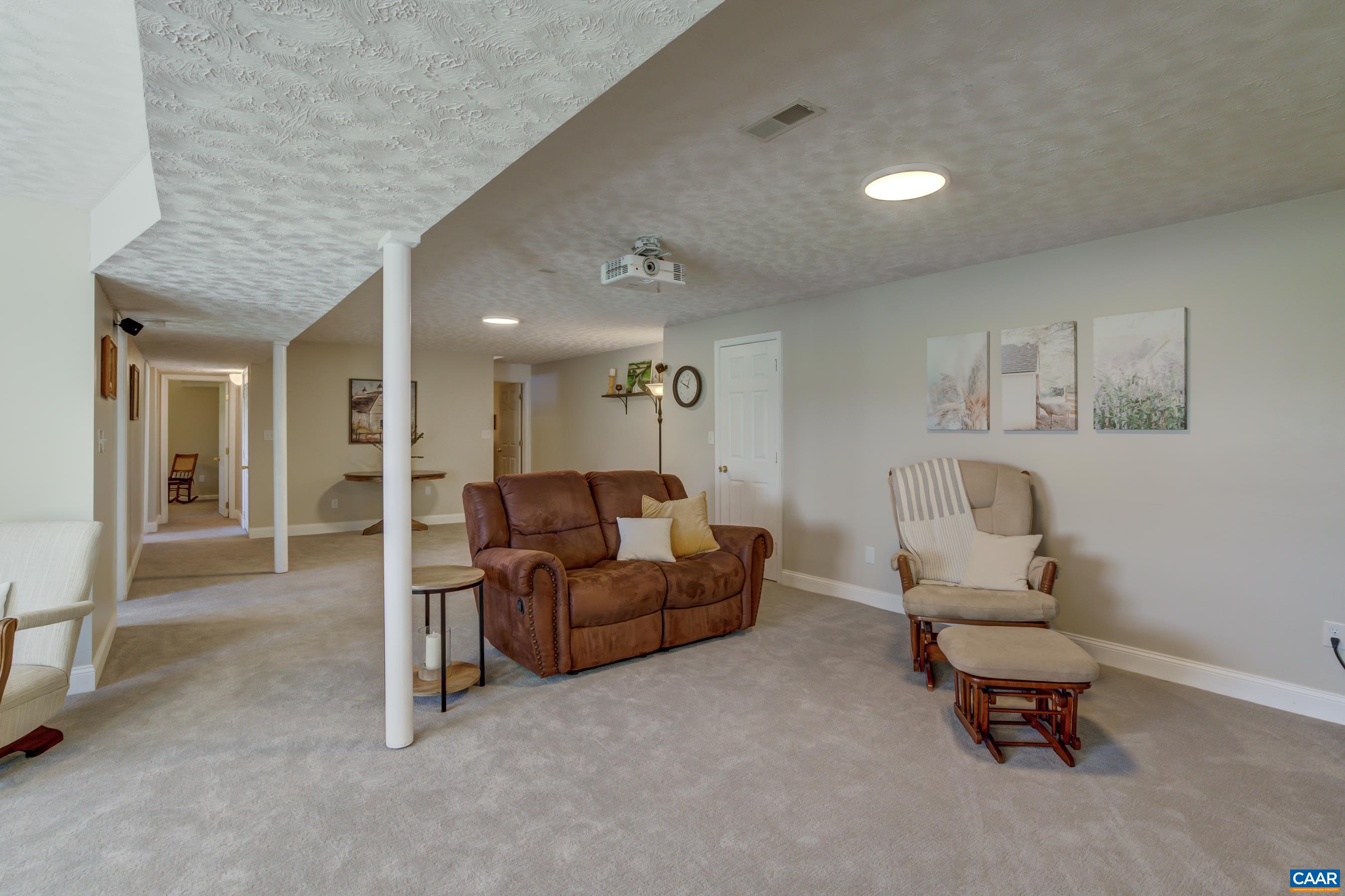 120 Meadowview Lane Ruckersville, VA 22968 - Photo 30 of 53 a living room with furniture and a mirror
