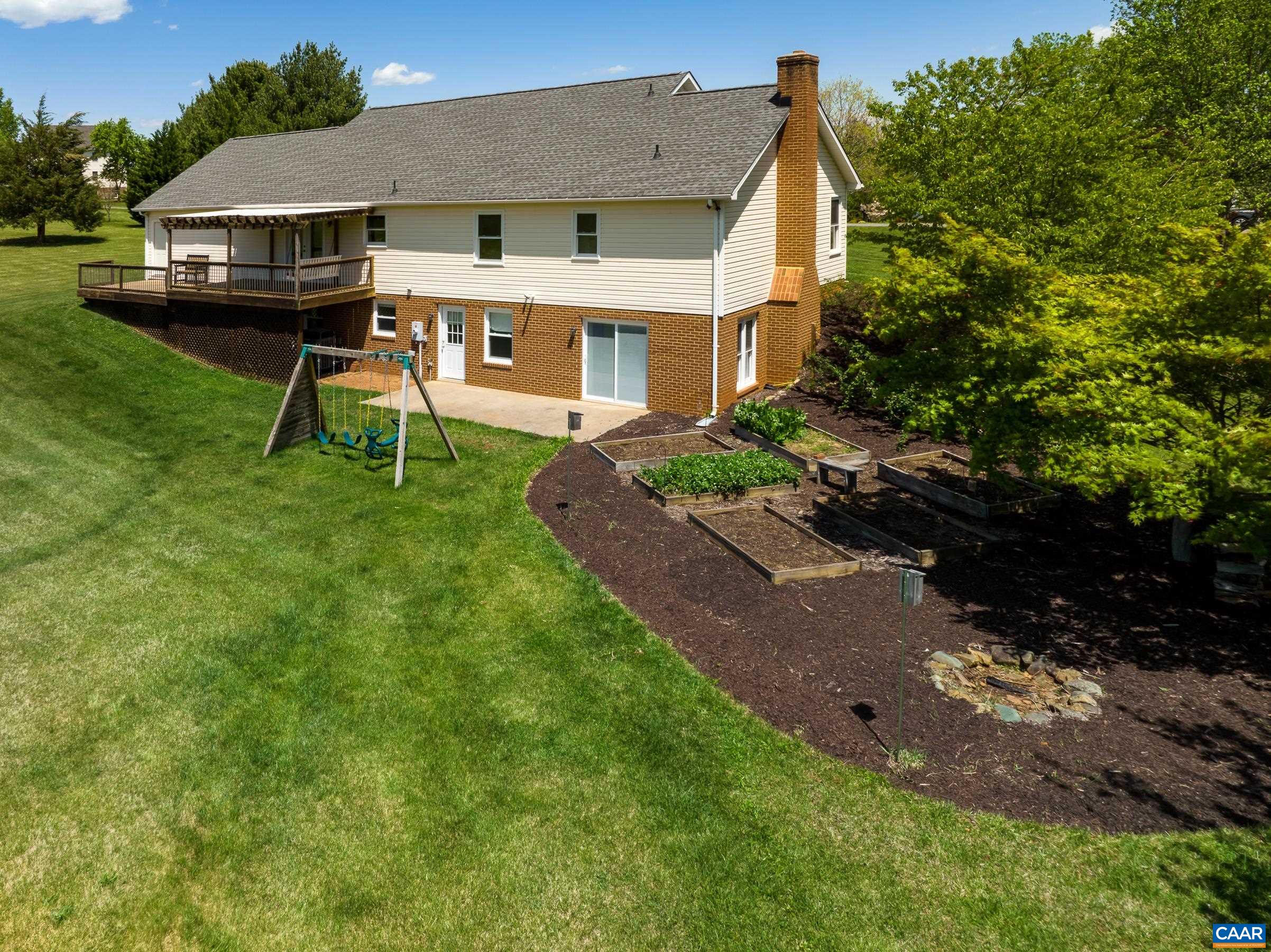 120 Meadowview Lane Ruckersville, VA 22968 - Photo 4 of 53 a front view of a house with a garden