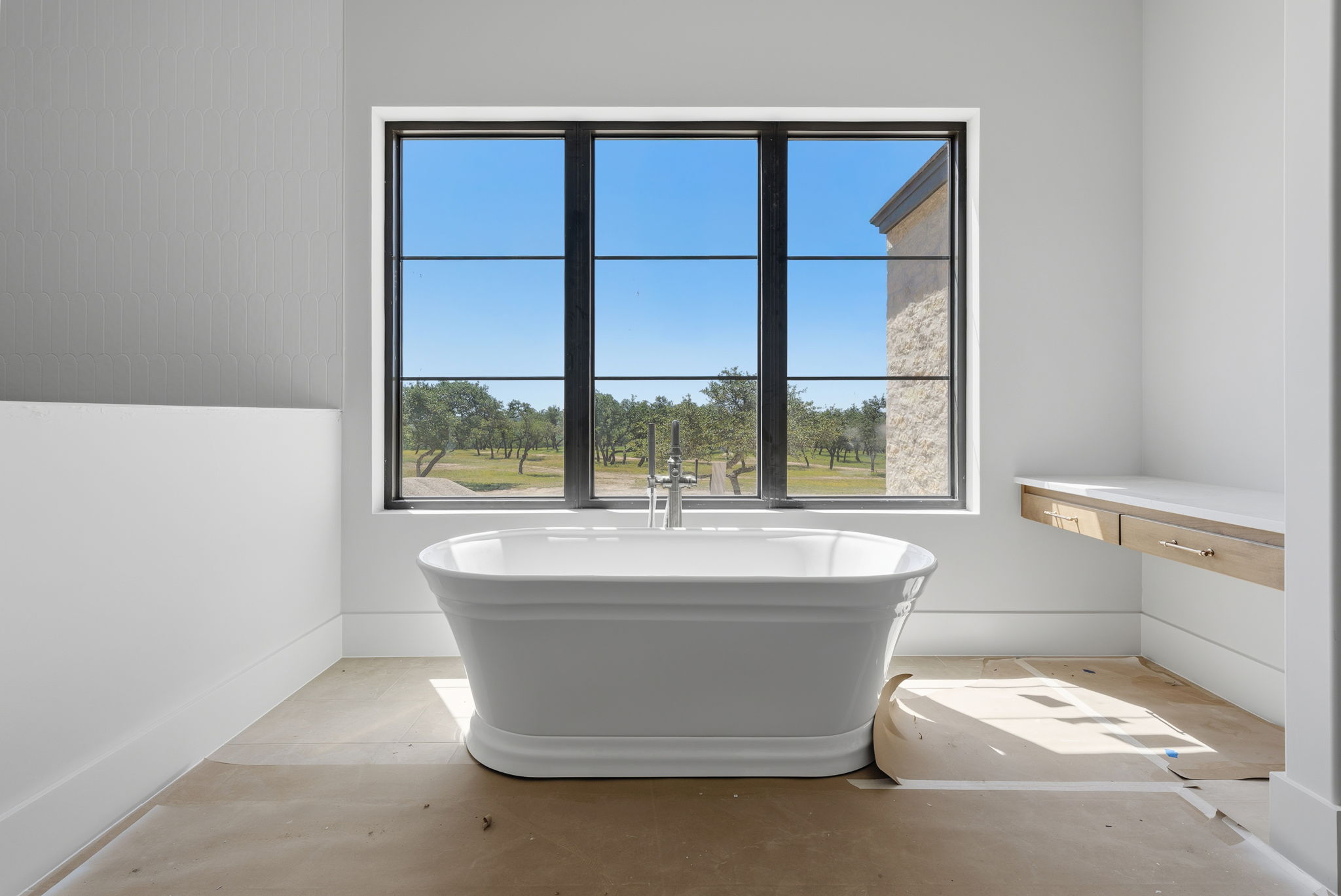 3300 Rm -165 Dripping Springs Dripping Springs, TX 78620 - Photo 9 of 32 a bath tub sitting in a bathroom next to a window