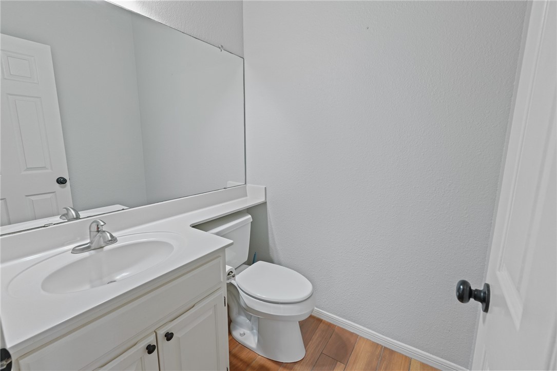 7617 Del Rio Drive Corpus Christi, TX 78413 - Photo 13 of 32 a bathroom with a toilet a sink and mirror