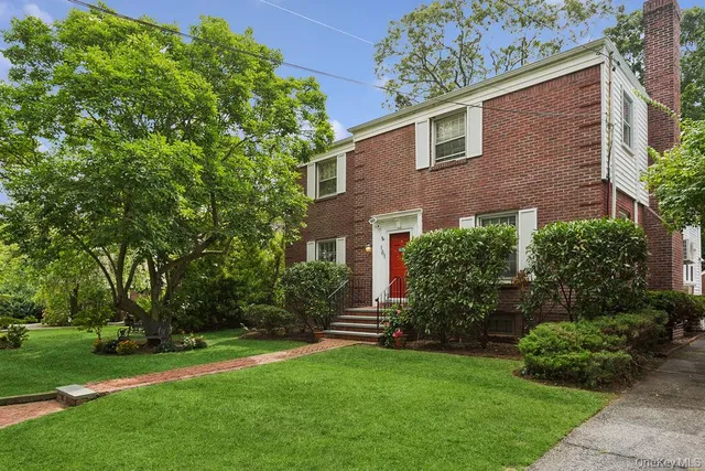 a front view of house with yard and green space