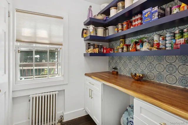 a utility room with multiple dryer and cabinets