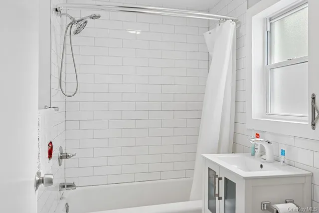 a bathroom with a shower and a sink
