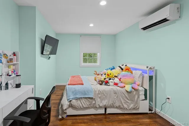 a bedroom with furniture and a wooden floor