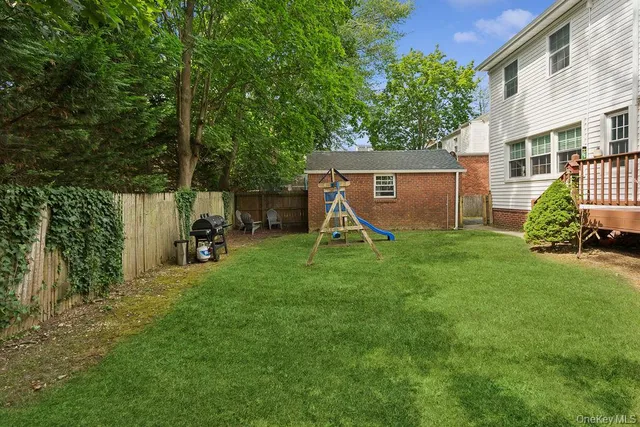 a view of a backyard with a sitting area and a slide