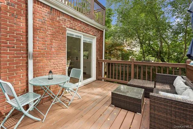 a view of a wooden deck with furniture