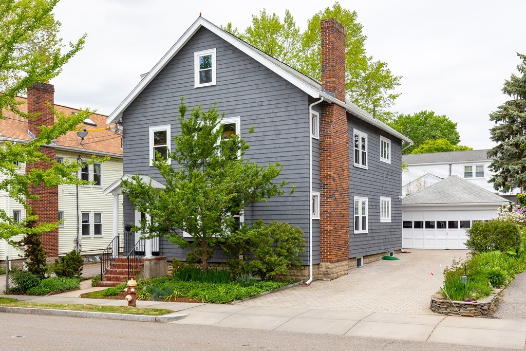 4 Hilltop Road Watertown, MA 02472 - Photo 1 of 27 a view of a house with a yard and plants