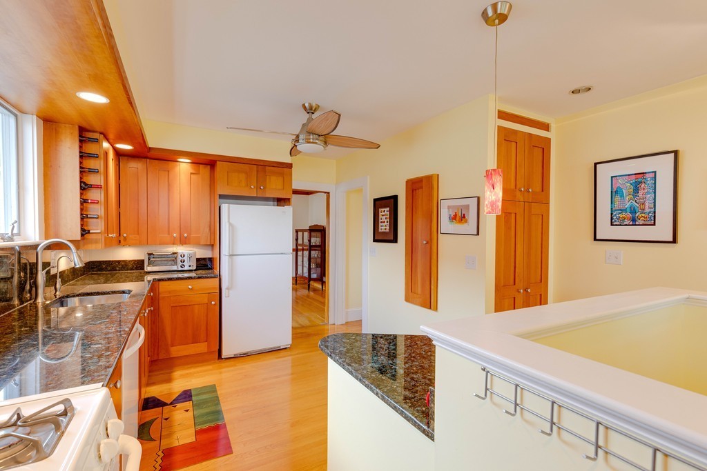 4 Hilltop Road Watertown, MA 02472 - Photo 13 of 27 a kitchen with stainless steel appliances granite countertop a sink and a refrigerator