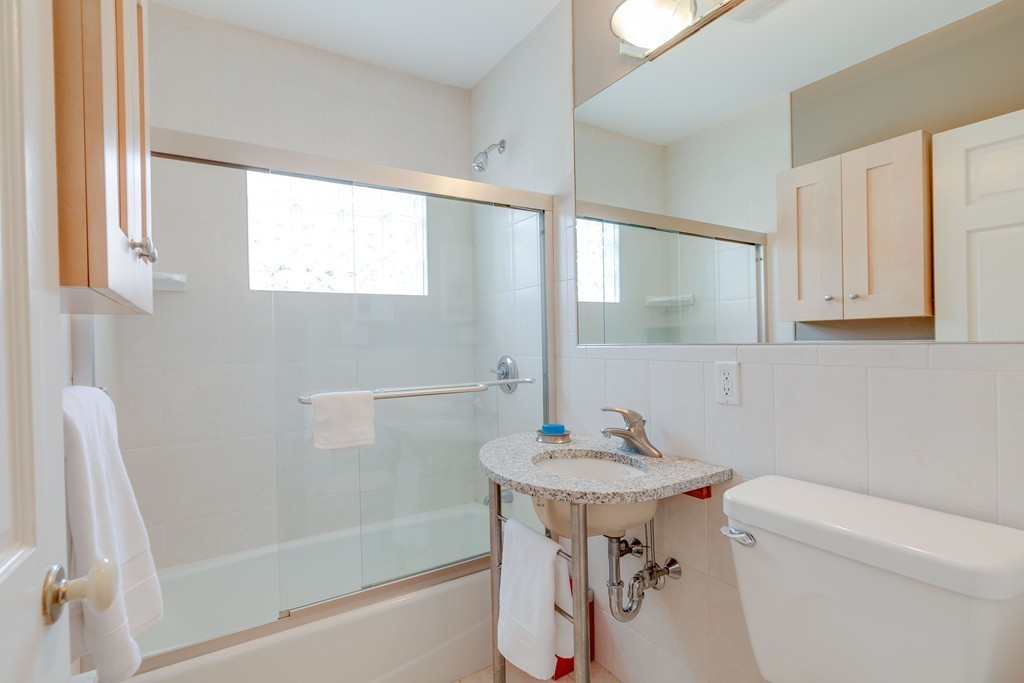 4 Hilltop Road Watertown, MA 02472 - Photo 17 of 27 a bathroom with a sink a toilet and a bathtub