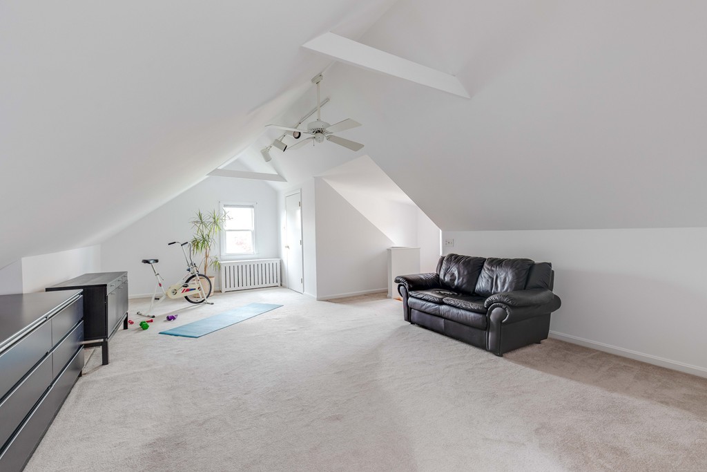 4 Hilltop Road Watertown, MA 02472 - Photo 21 of 27 a living room with furniture and a fireplace