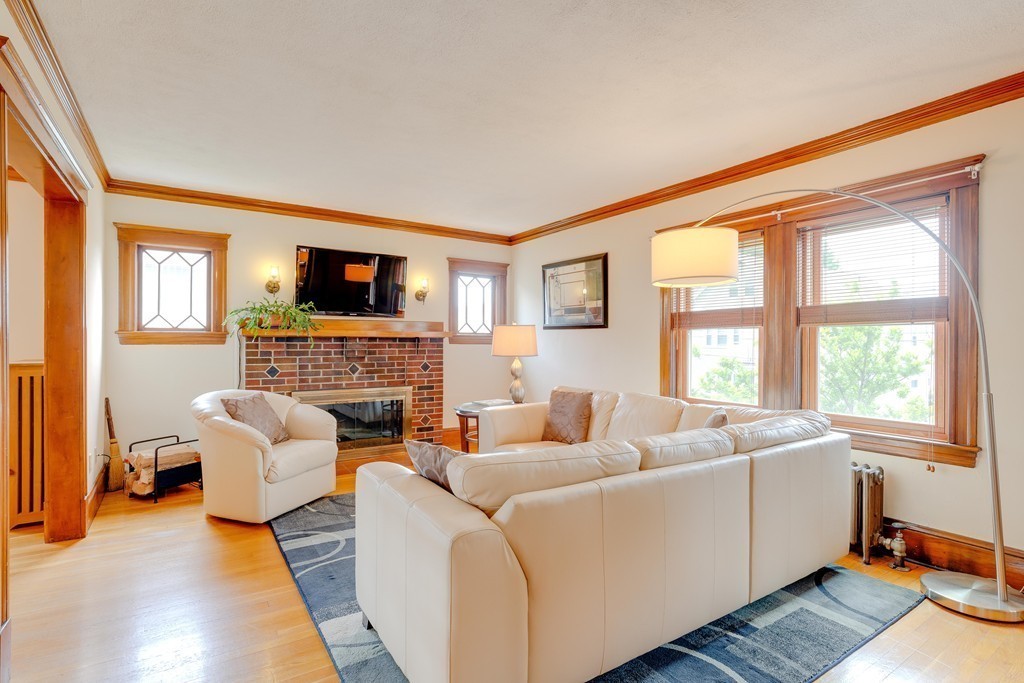 4 Hilltop Road Watertown, MA 02472 - Photo 4 of 27 a living room with furniture a fireplace and a flat screen tv