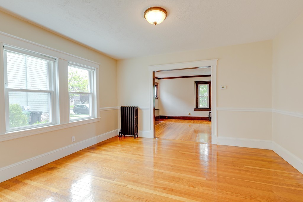 4 Hilltop Road Watertown, MA 02472 - Photo 9 of 27 a view of empty room with wooden floor and fan