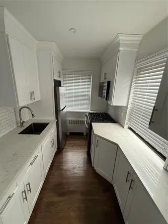 a kitchen with a sink and a stove top oven