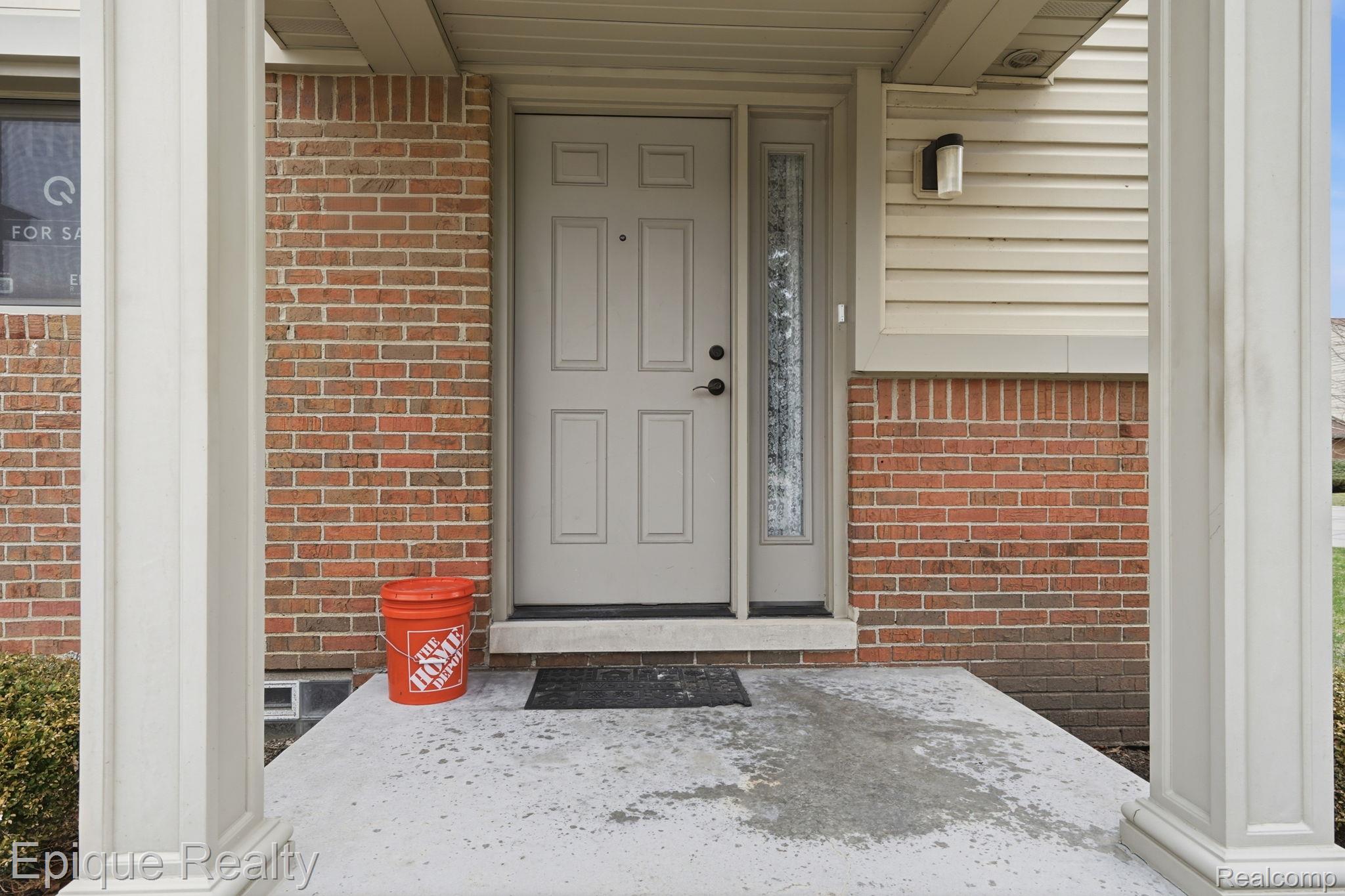 3895 Old Creek Road Troy, MI 48084 - Photo 8 of 23 Property entrance featuring brick siding, covered porch, and crawl space