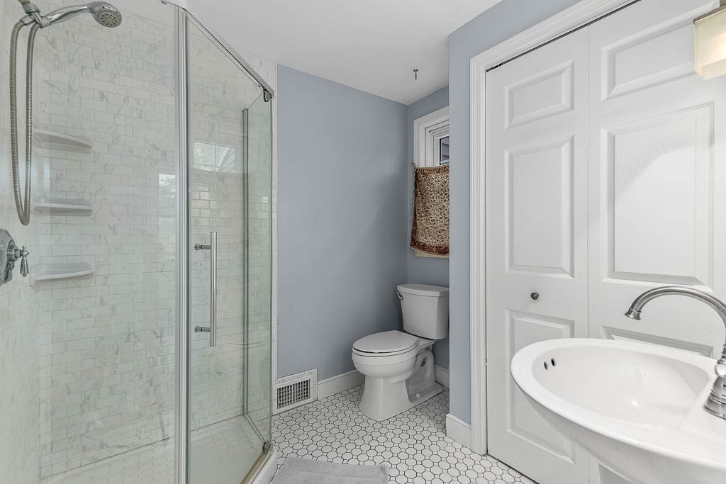 34 Cranberry Lane Dedham, MA 02026 - Photo 17 of 38 a bathroom with a sink a toilet and shower