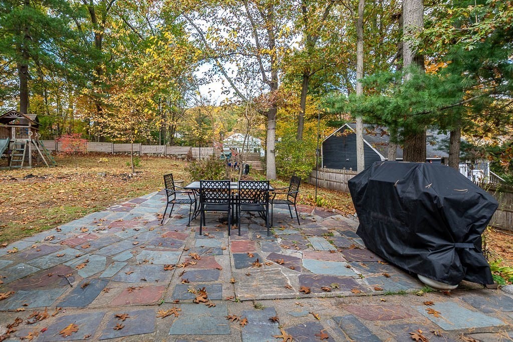 34 Cranberry Lane Dedham, MA 02026 - Photo 30 of 38 a backyard of a house with table and chairs