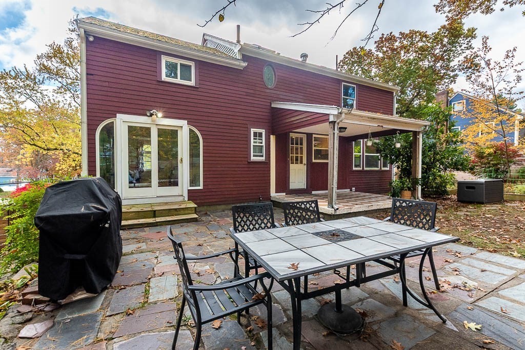 34 Cranberry Lane Dedham, MA 02026 - Photo 32 of 38 a view of a patio with table and chairs and potted plants