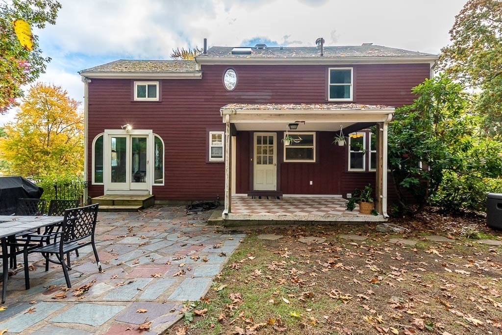 34 Cranberry Lane Dedham, MA 02026 - Photo 36 of 38 a view of a brick house with a yard and lawn chairs with a fire pit