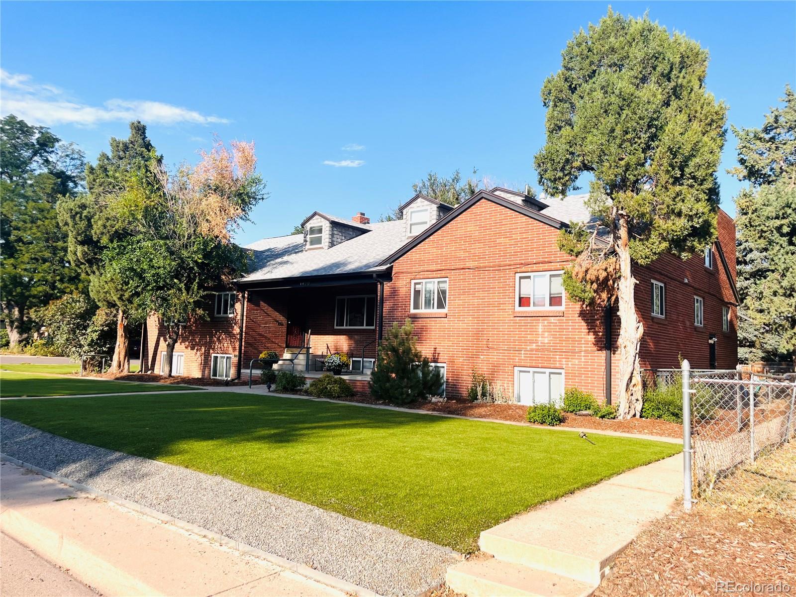1400 South Clermont Street, Unit 8 Denver, CO 80222 - Photo 1 of 11 a view of a white house with a yard and potted plants