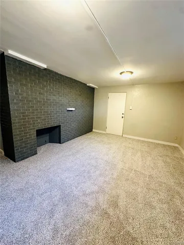 a view of an empty room with a fireplace
