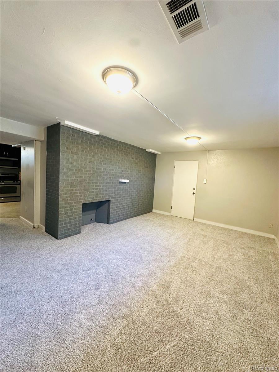 1400 South Clermont Street, Unit 8 Denver, CO 80222 - Photo 7 of 11 an empty room with kitchen and glass door