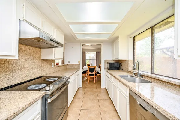 a large kitchen with a stove top oven