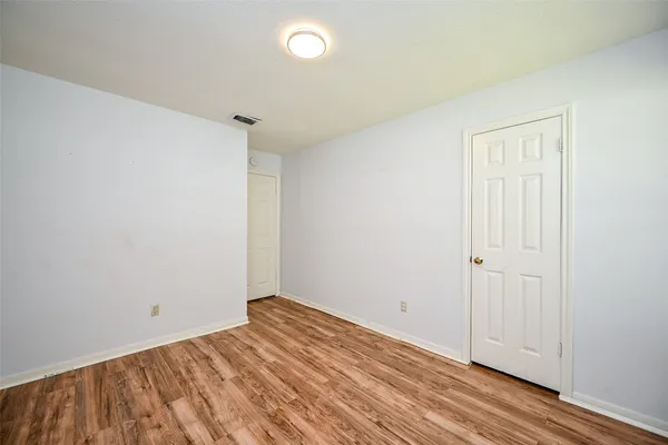 a view of room with wooden floor