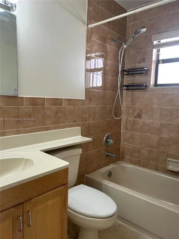 a kitchen with stainless steel appliances granite countertop a refrigerator a stove a sink and a microwave