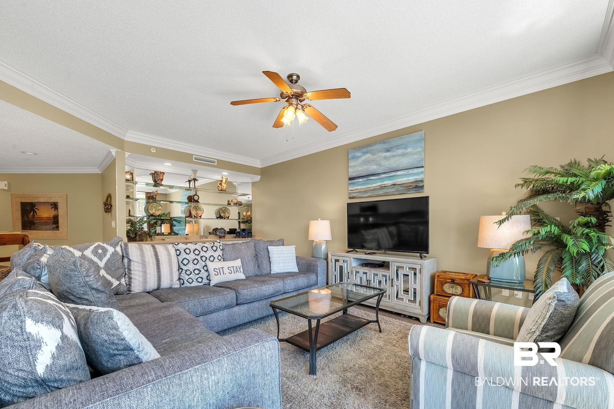 27580 Canal Road, Unit 1214 AND BOAT SLIP #62 Orange Beach, AL 36561 - Photo 10 of 67 Living area featuring visible vents, ornamental molding, and a ceiling fan