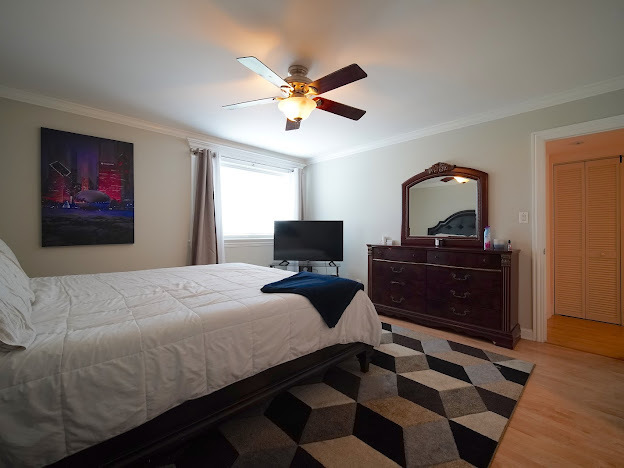 5744 106th Street, Unit 3C Chicago Ridge, IL 60415 - Photo 13 of 19 a bedroom with a bed and a chandelier