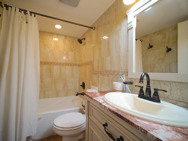 5744 106th Street, Unit 3C Chicago Ridge, IL 60415 - Photo 16 of 19 a bathroom with a sink a toilet a mirror and shower