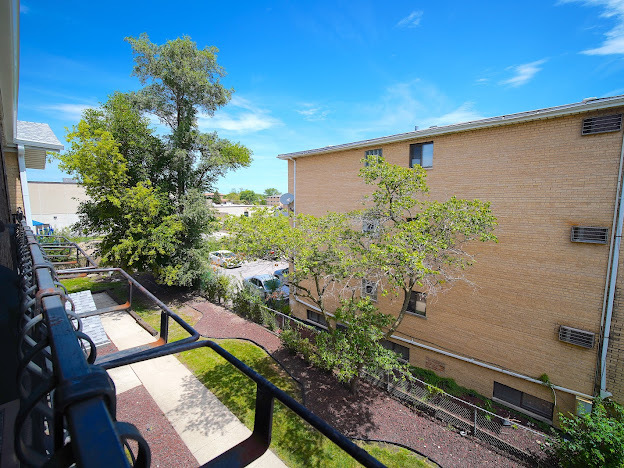 5744 106th Street, Unit 3C Chicago Ridge, IL 60415 - Photo 18 of 19 a backyard of a house with lots of green space and a fountain