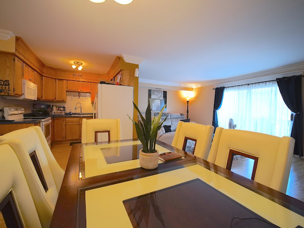 5744 106th Street, Unit 3C Chicago Ridge, IL 60415 - Photo 5 of 19 a view of kitchen and dining room with furniture wooden floor and window