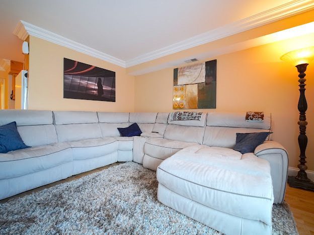 5744 106th Street, Unit 3C Chicago Ridge, IL 60415 - Photo 8 of 19 a living room with furniture and a flat screen tv