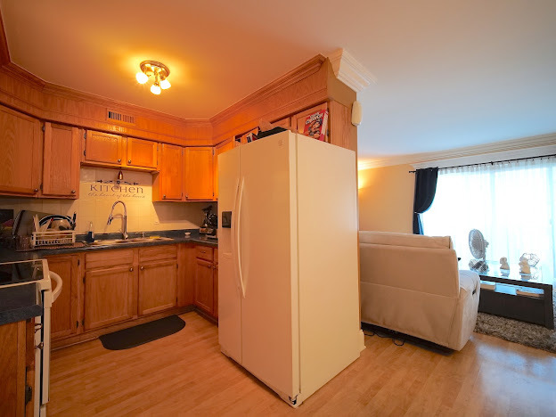 5744 106th Street, Unit 3C Chicago Ridge, IL 60415 - Photo 9 of 19 a kitchen with stainless steel appliances granite countertop a refrigerator a sink and white cabinets