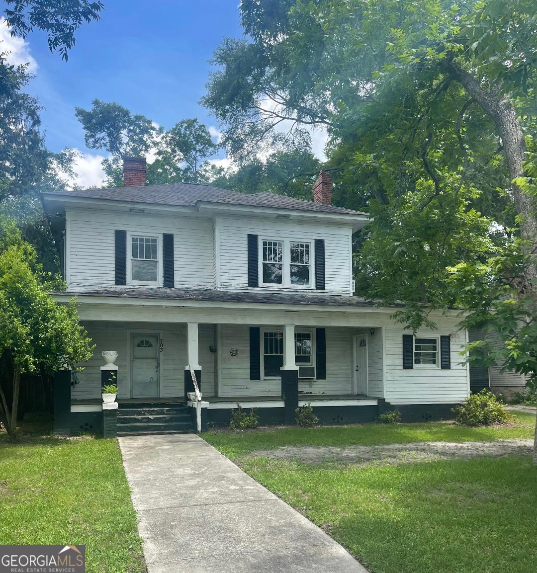 front view of a house with a yard