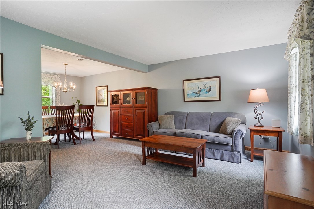 4190 Springdale Road Stow, OH 44224 - Photo 4 of 38 Carpeted living room featuring a chandelier and baseboards