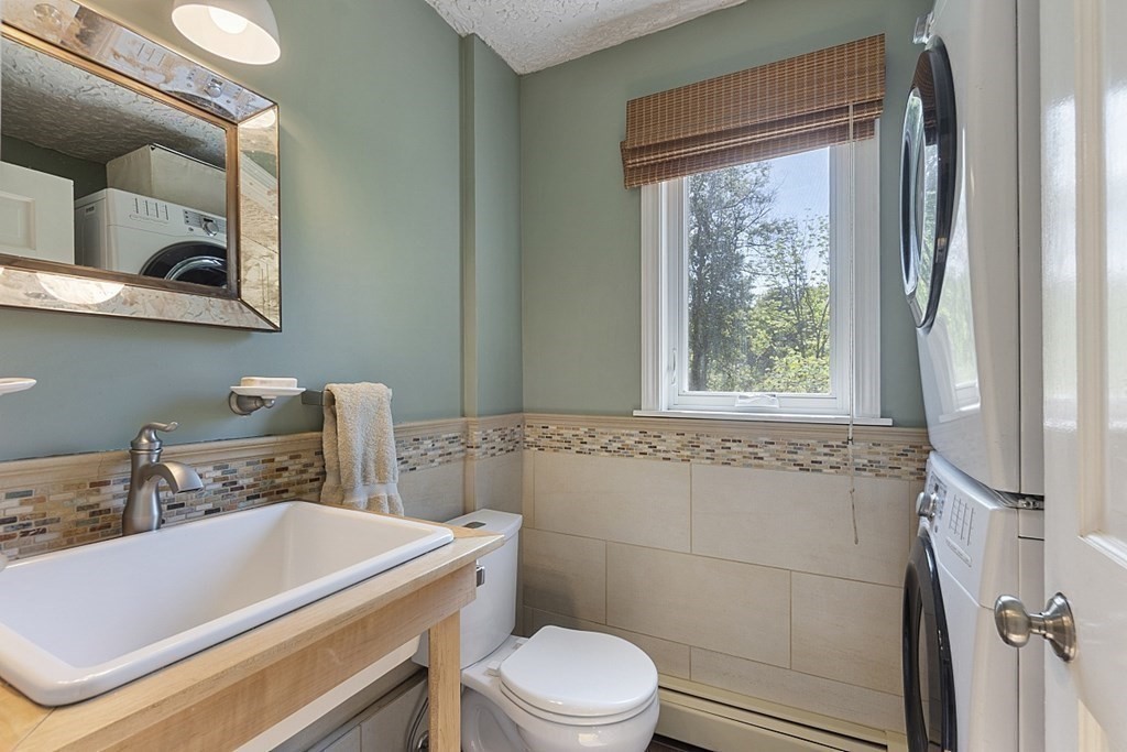 208 Concord Road Lincoln, MA 01773 - Photo 18 of 23 a bathroom with a sink a toilet and shower