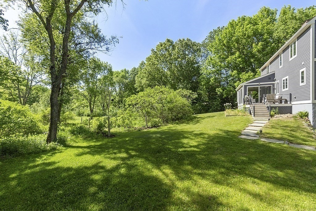 208 Concord Road Lincoln, MA 01773 - Photo 21 of 23 a view of a yard with plants and large trees
