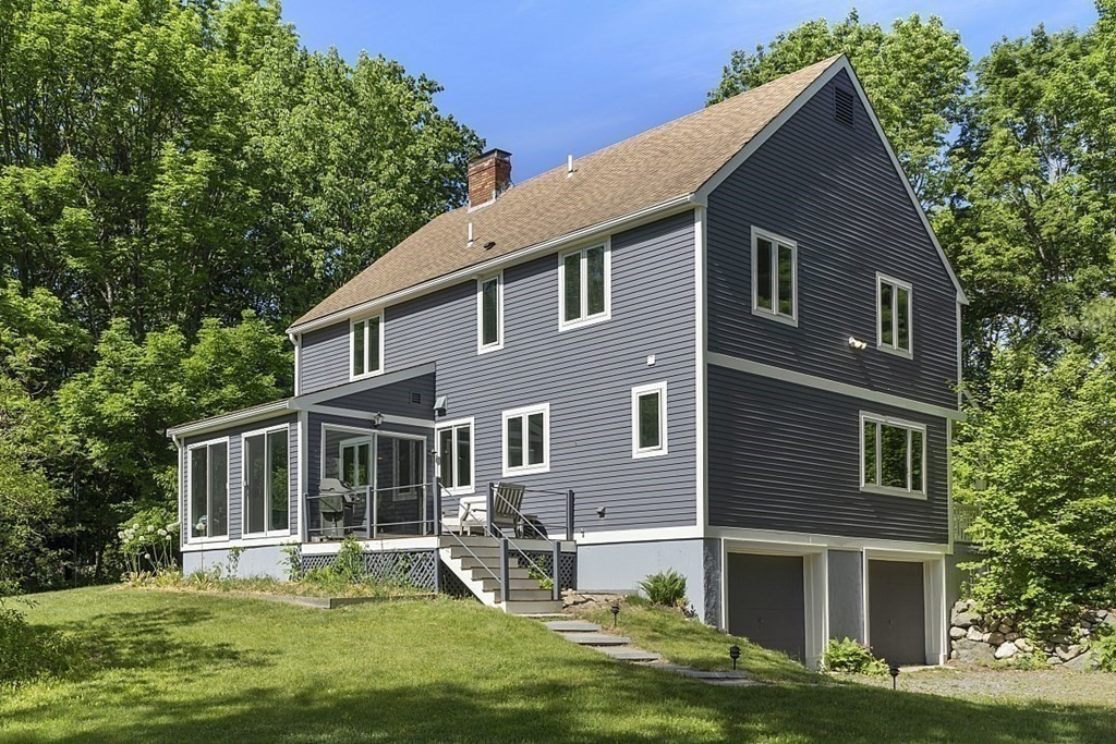 208 Concord Road Lincoln, MA 01773 - Photo 22 of 23 a front view of house with yard and trees in the background