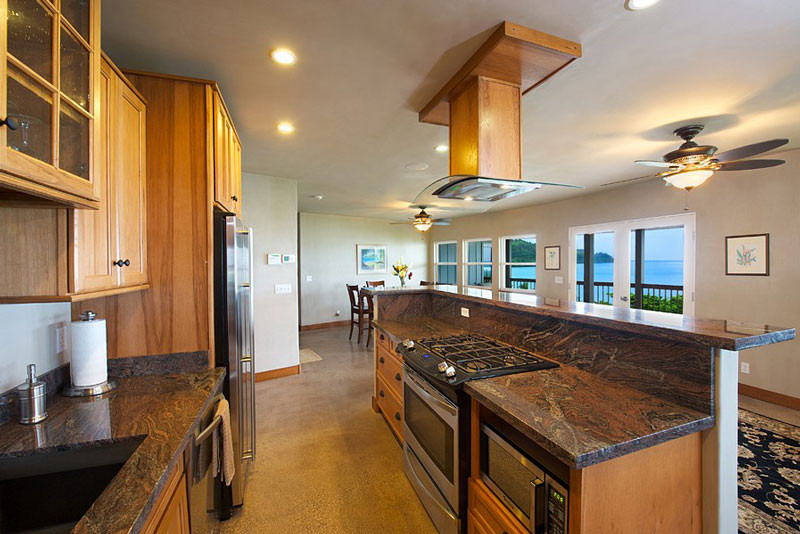 4241 Anini Road Princeville, HI 96722 - Photo 13 of 24 a kitchen with stainless steel appliances granite countertop a sink and a refrigerator