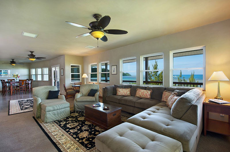 4241 Anini Road Princeville, HI 96722 - Photo 15 of 24 a living room with furniture a rug and a chandelier