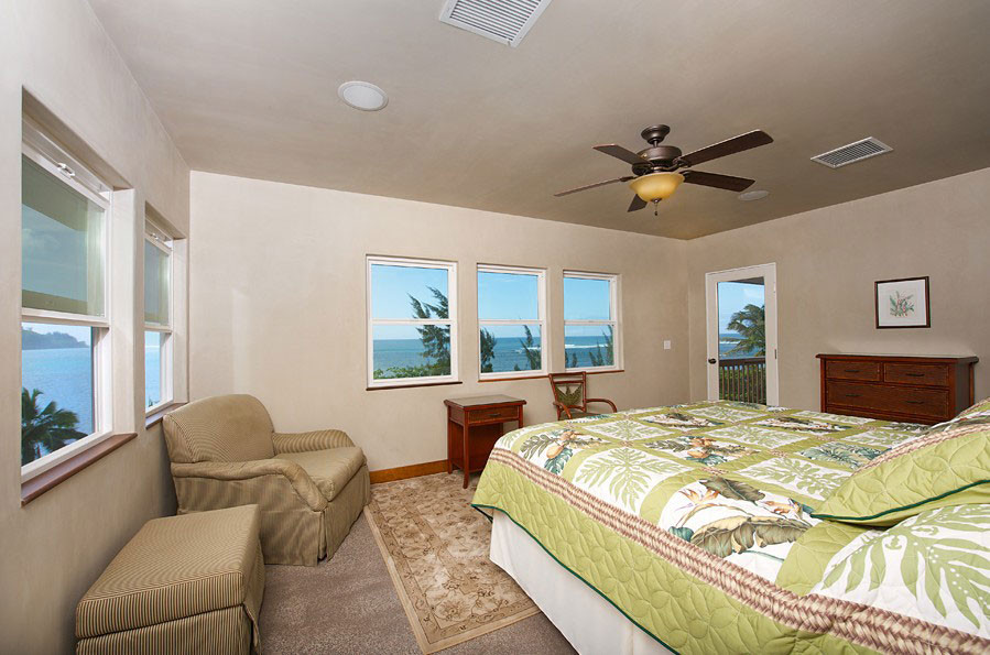 4241 Anini Road Princeville, HI 96722 - Photo 17 of 24 a bedroom with a large bed couch and a window