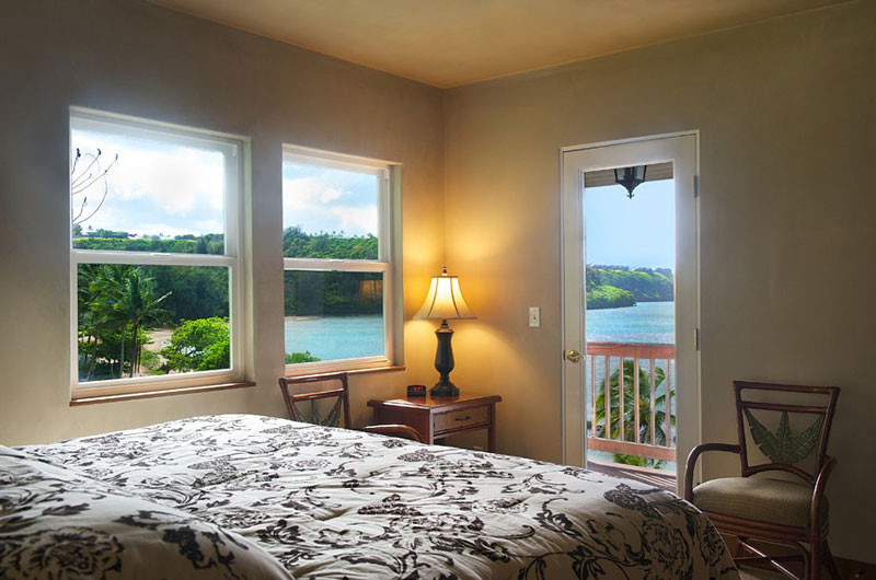 4241 Anini Road Princeville, HI 96722 - Photo 18 of 24 a bedroom with a bed and wooden floor