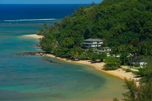a backyard of a house with lots of green space and lake view