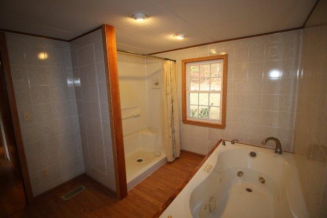 720 Wooten Park Road Red Boiling Springs, TN 37150 - Photo 8 of 29 a bathroom with a bathtub and a shower