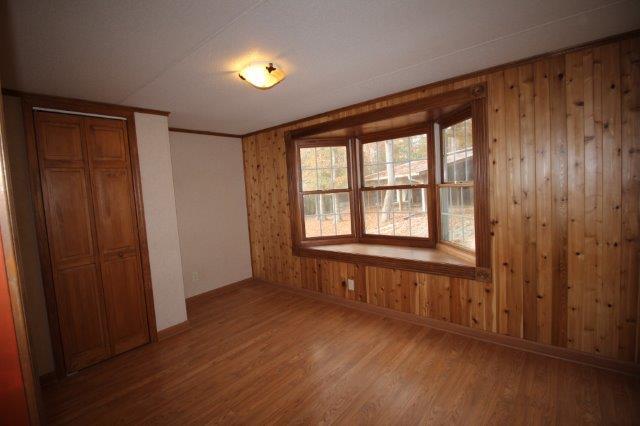 720 Wooten Park Road Red Boiling Springs, TN 37150 - Photo 10 of 29 an empty room with wooden floor and windows