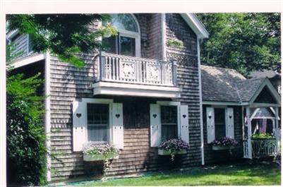27 Bayview Road Mashpee, MA 02649 - Photo 2 of 35 a view of a house with brick walls and a yard with plants